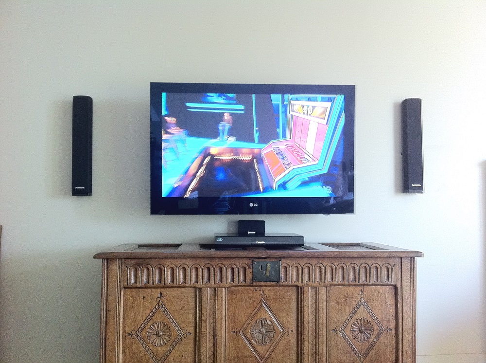 speakers and a tv put on a tilt wall mount in remuera