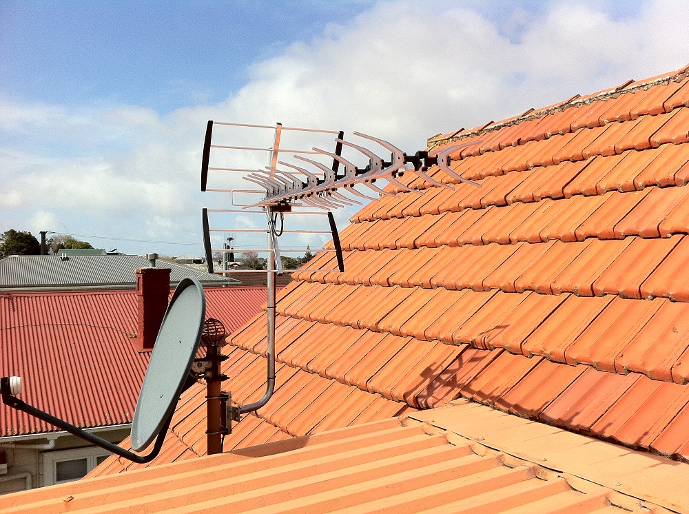 a uhf aerial clamped on a satellite dish out in mount roskill